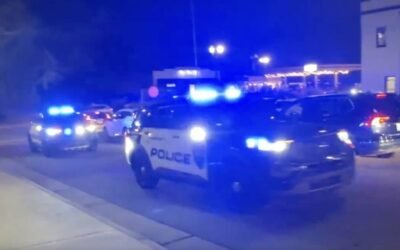 PHOTO: Several police vehicles sound sirens after reports of shots fired at Christmas Tree Lighting in Concord, North Carolina.