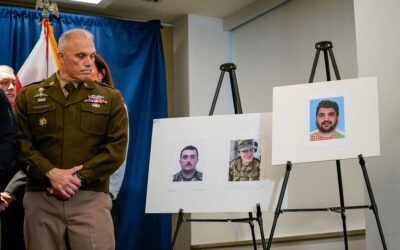 PHOTO: Brigadier General Leland D. Blanchard II looks at photos of two National Guard members who were shot along with a photo of a suspect, Afghan national Rahmanullah Lakanwal, at a news conference in Washington, DC, Nov. 27, 2025.